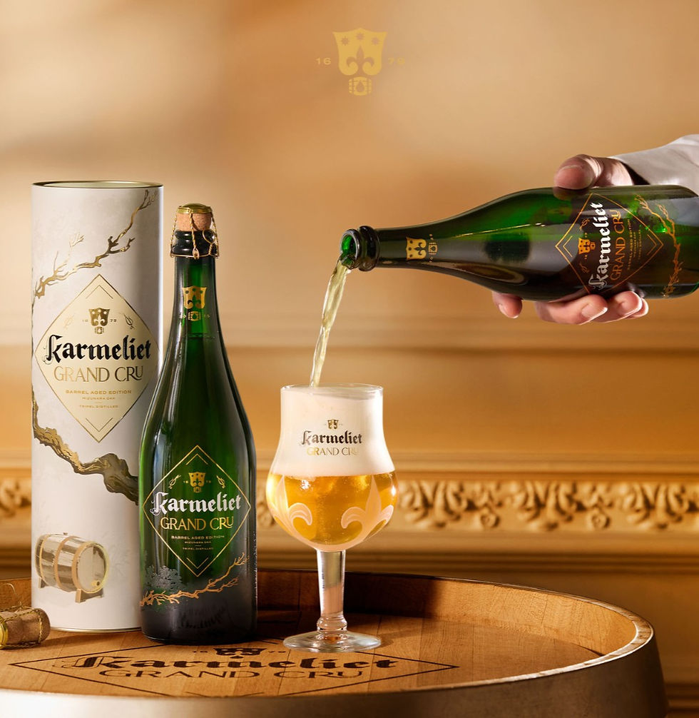 Tripel Karmeliet Grand Cru 2025 Barrel Aged Edition glass and packaging with a hand pouring the beer.
